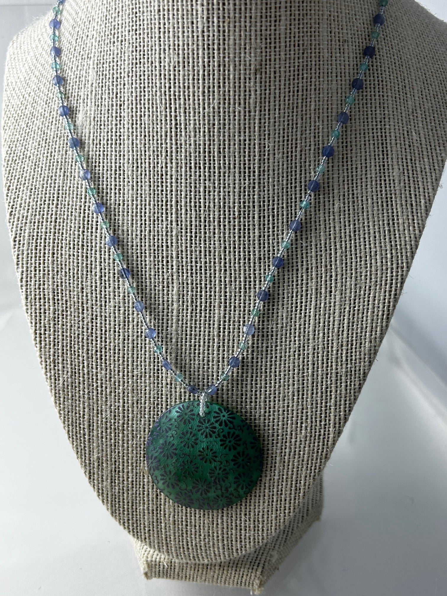 Necklace, finished jewelry, Mother of pearl 35mm pendant with aquamarine and tanzanite semi precious stones with sterling silver ext clasp