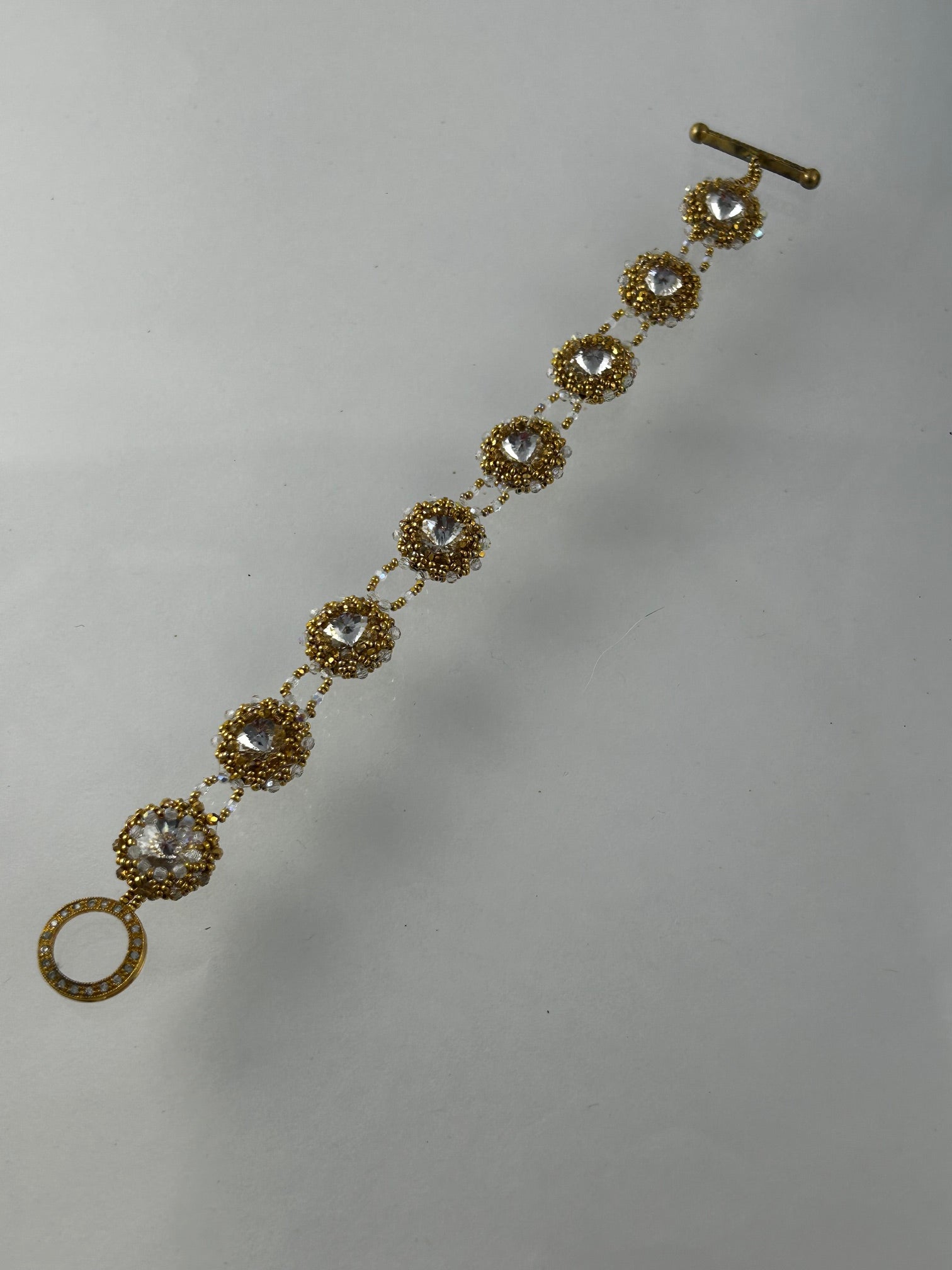 Bracelet, finished jewelry, 12mm crystal rivoli with 2mm aurum and crystal bicones with gold vermeil fancy clasp