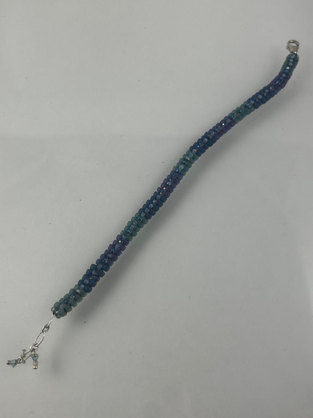 Mixed matte herringbone bracelet with matching crystals with silver lobster claw and chain closure! $50.00